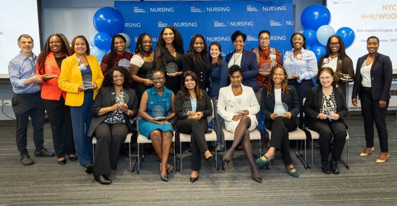 A diverse group of nurse leaders gathered at a professional recognition event